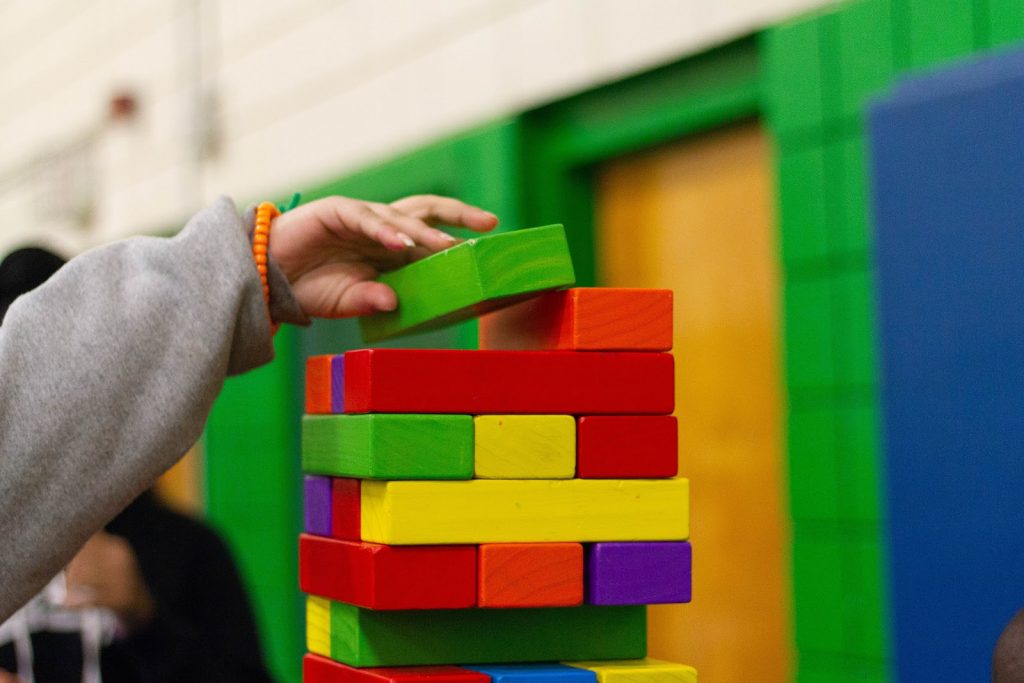 a kid using colourful building blocks