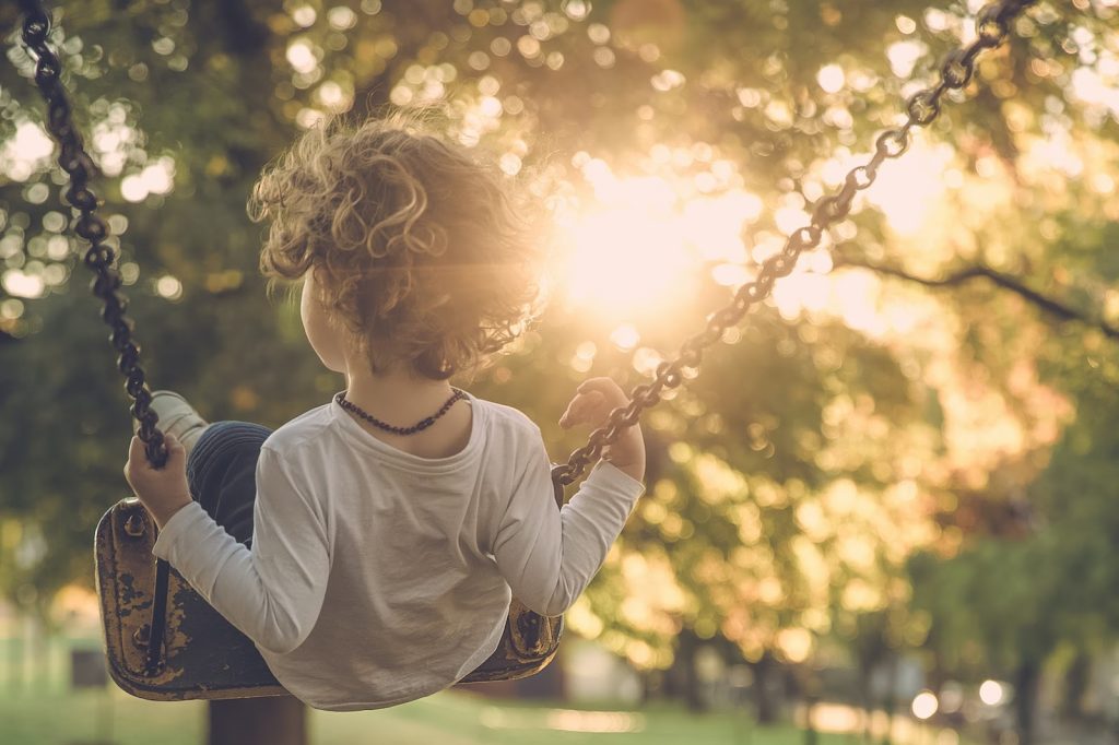 a child swinging on a swing