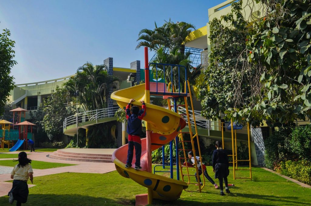 a playground with a yellow winding slide