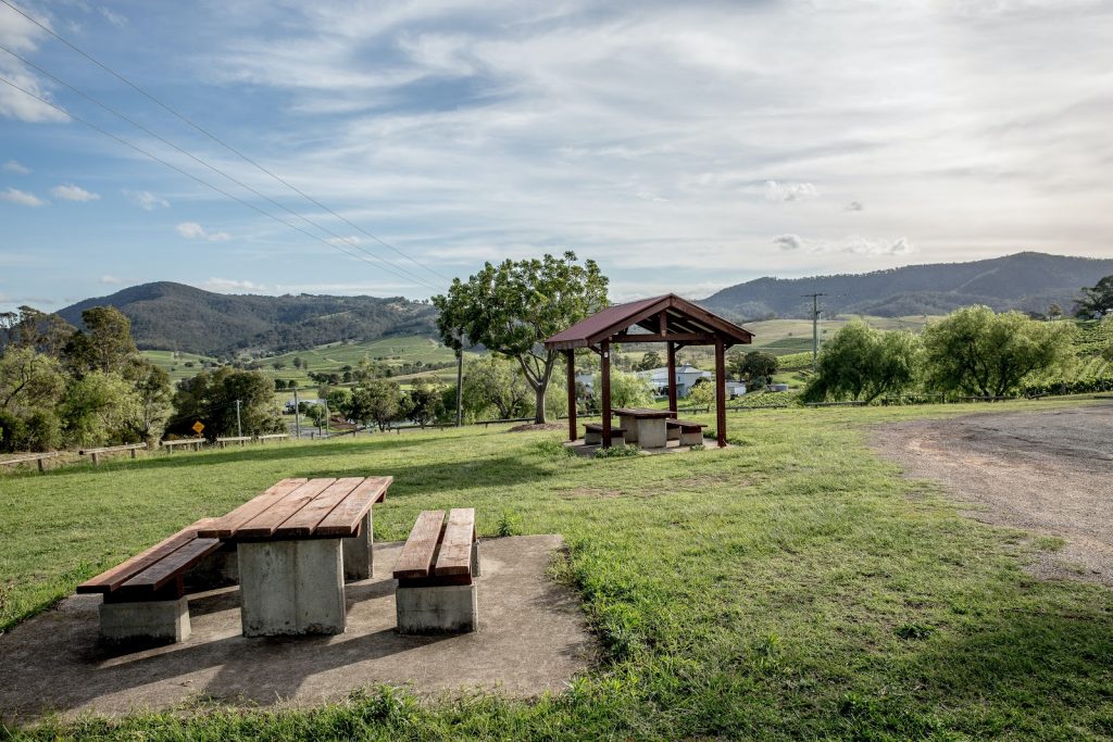 a open field with a picnic table