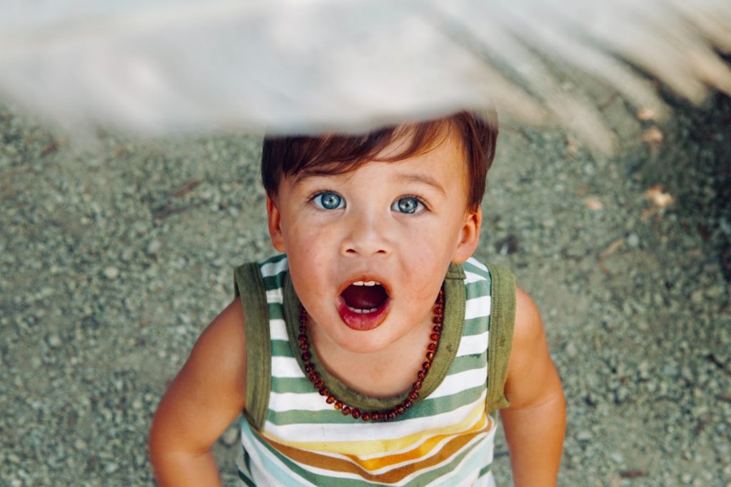 a small boy looking up at something off camera in awe