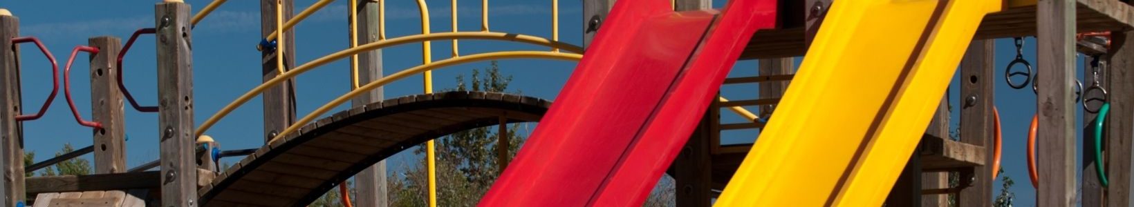 A small playground with two slides side by side.