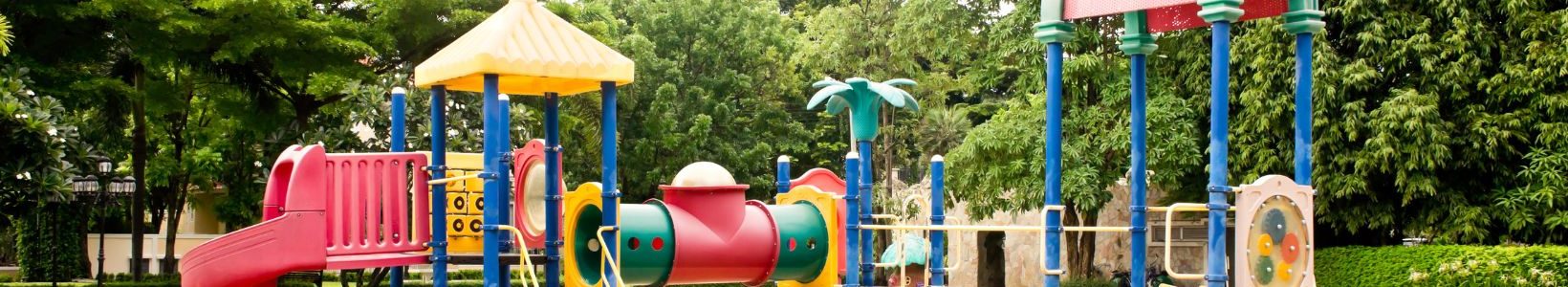 An outdoor playground with sand as the surface.