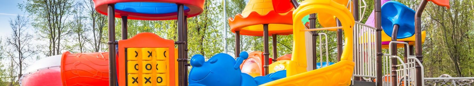 A Plastic playground with multiple slides and an activity panel.